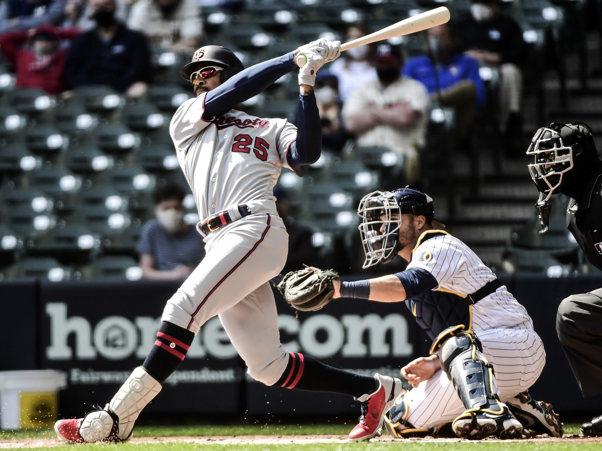 Apr 4, 2021; Milwaukee, Wisconsin, USA;  Minnesota Twins center fielder Byron Buxton (25) hits a double in the first inning as Milwaukee Brewers catcher Manny Pina (9) watches at American Family Field.